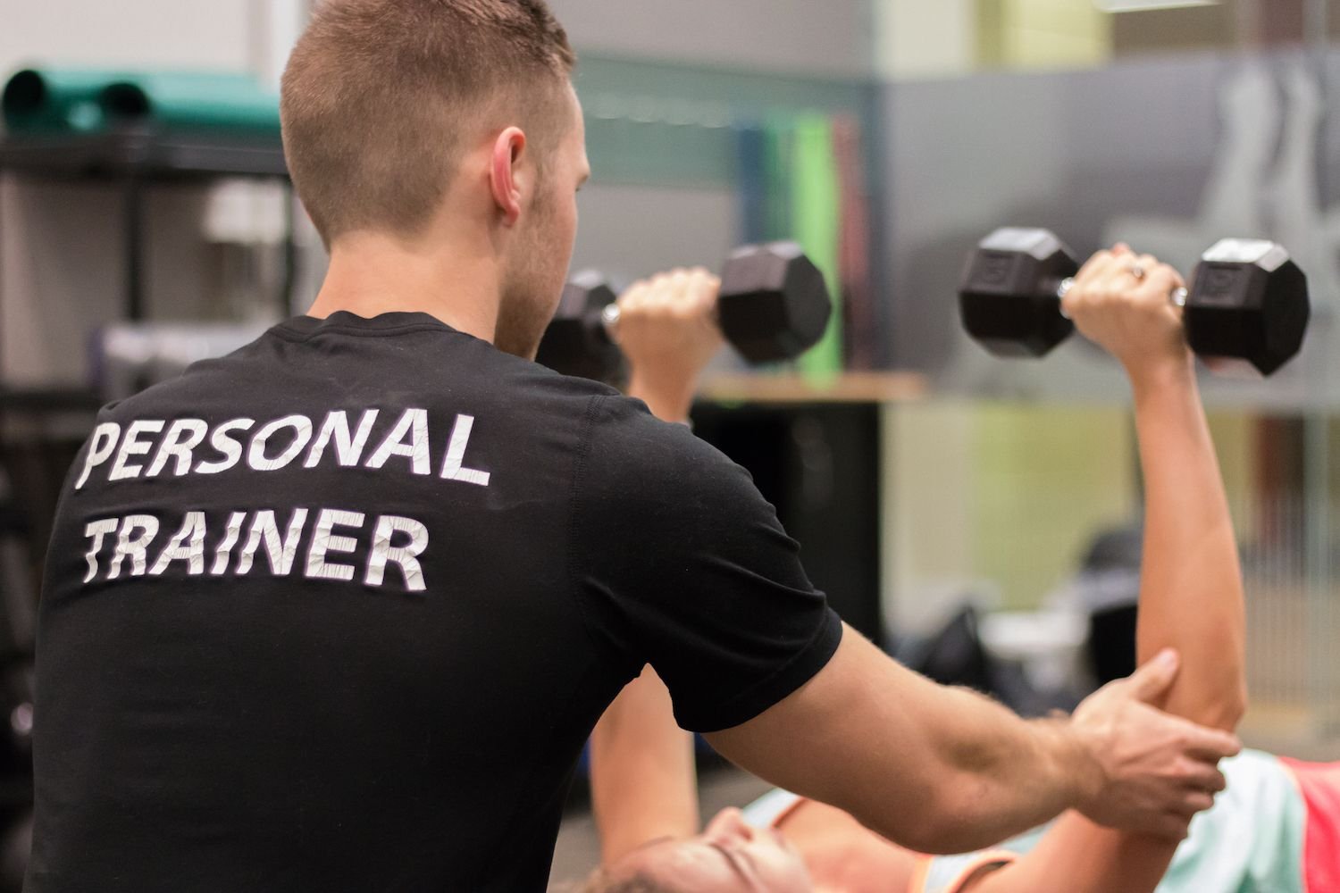 Personal trainer working with client